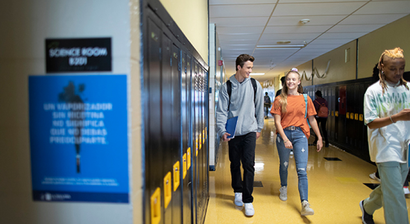 teens walking and talking in hallway
