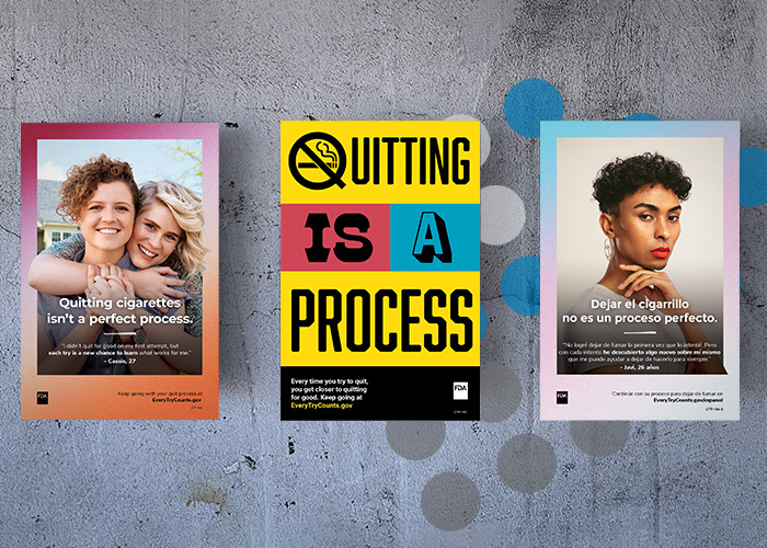 Posters about Quitting Smoking hang on a concrete wall